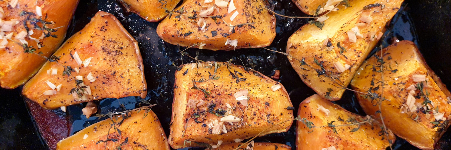 Close up of Jalapeno Garlic Roasted Squash in a black fry pan.