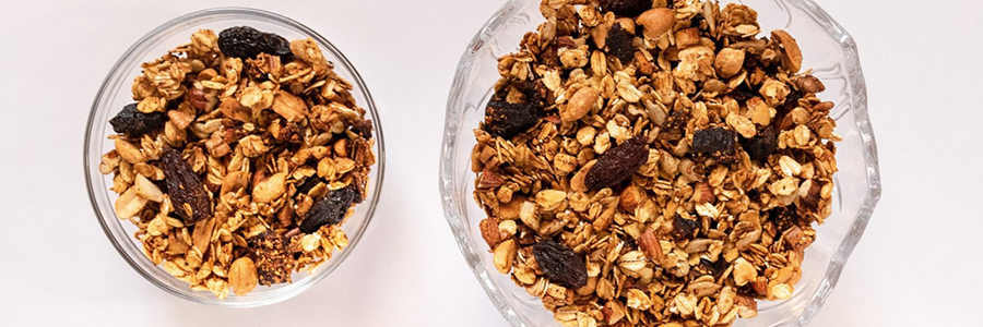 Overhead shot of two bowls, one large and one small, of trail mix.