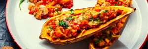smothered-sweetpotatoes White platter with halved sweet potatoes topped with salsa, black beans, and cheese.