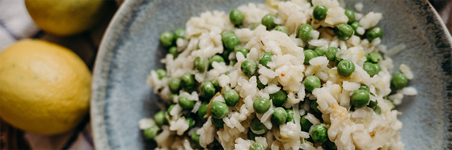 Shot of peas and rice on a blue stoneware plate.