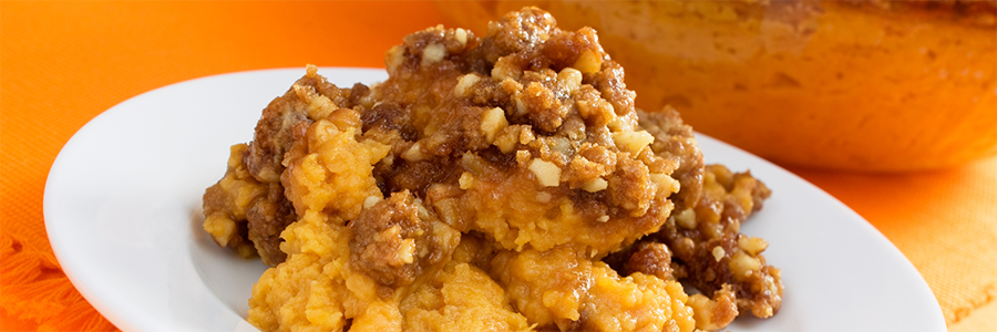 Close up of mashed pumpkin with honey and crumbled graham crackers.