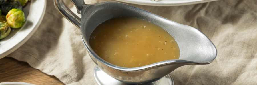 pewter gravy boat filled with turkey gravy