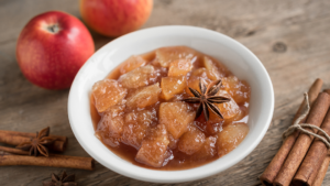 A bowl of apple compote garnished with star anise