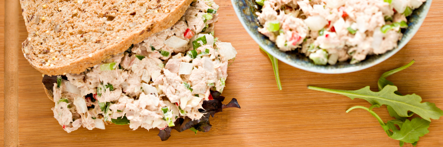 bowl full of tuna salad with celery and raisins