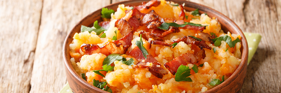 Blend of mashed carrots and potatoes topped with chopped bacon and parsley.