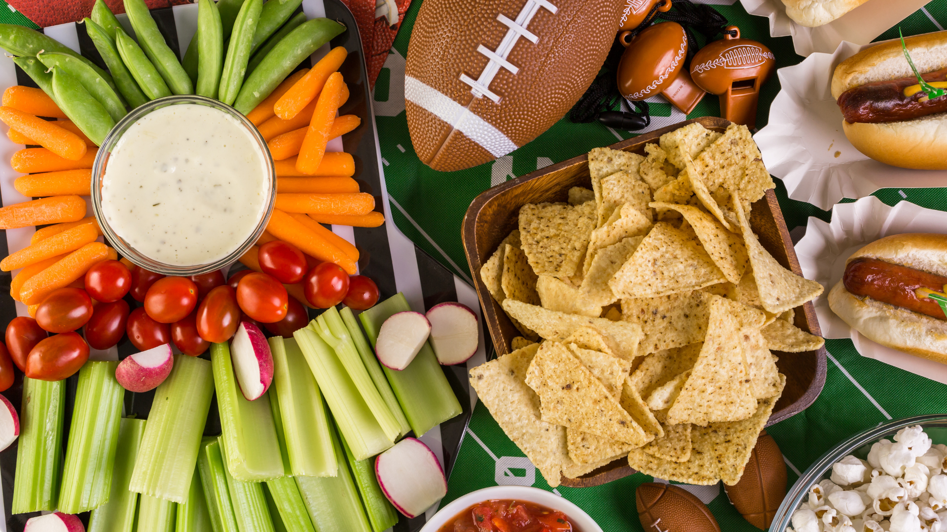 tailgate-blog Game day football spreads with a platter of celery, carrots, peas, and radishes displayed next to bowls of tortilla chips, salsa, and popcorn.